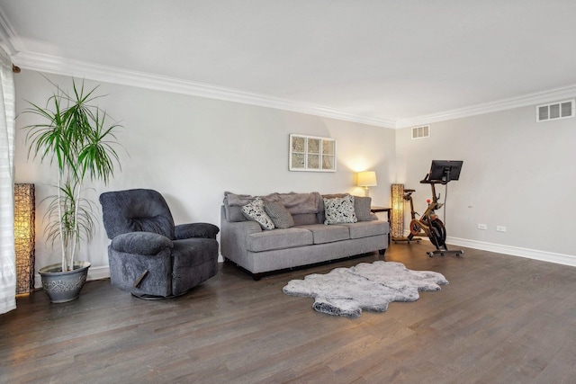 living area featuring baseboards, wood finished floors, visible vents, and crown molding