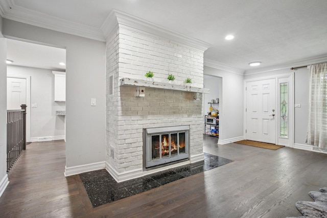 unfurnished living room with recessed lighting, baseboards, a brick fireplace, dark wood-style floors, and crown molding