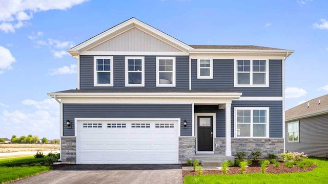 craftsman house with a garage, stone siding, and aphalt driveway