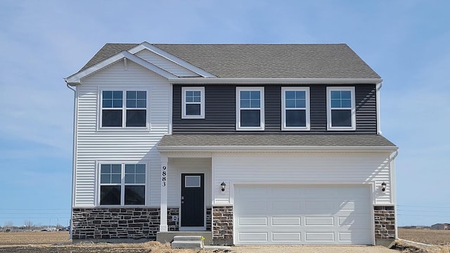 view of front of property featuring an attached garage, stone siding, and roof with shingles