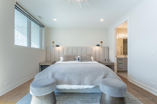 bedroom with recessed lighting, wood finished floors, visible vents, and baseboards