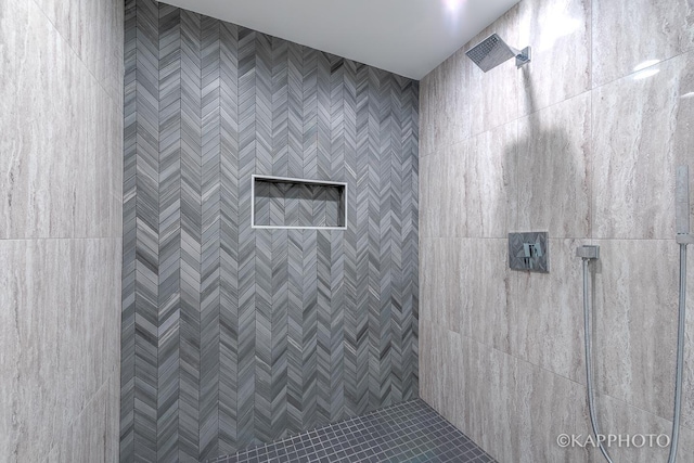 full bath with a tile shower