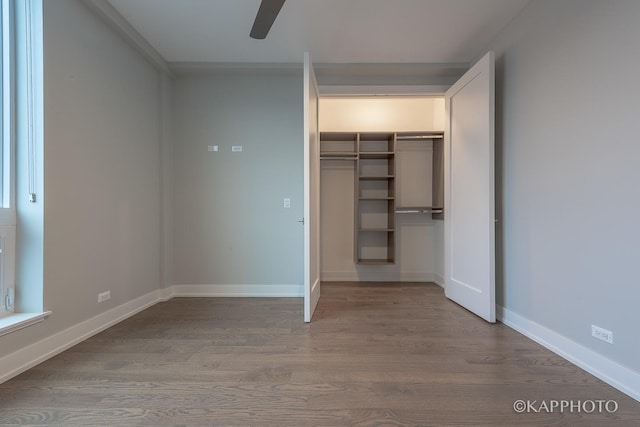 unfurnished bedroom with ceiling fan, a closet, baseboards, and wood finished floors