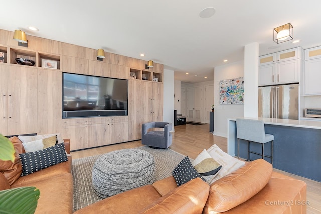 living area featuring recessed lighting, a toaster, and light wood-style flooring