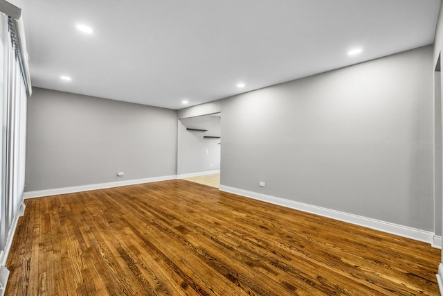 below grade area with baseboards, wood finished floors, and recessed lighting