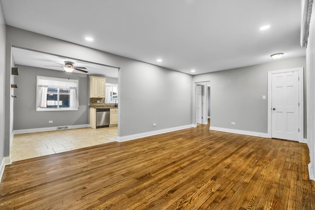 unfurnished living room with ceiling fan, recessed lighting, visible vents, baseboards, and light wood-type flooring