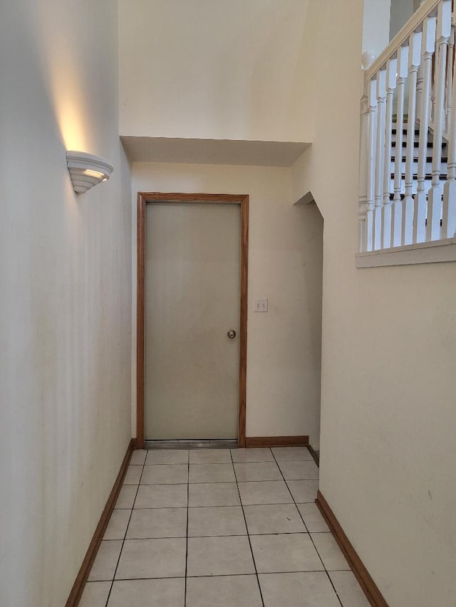 interior space with baseboards and light tile patterned flooring