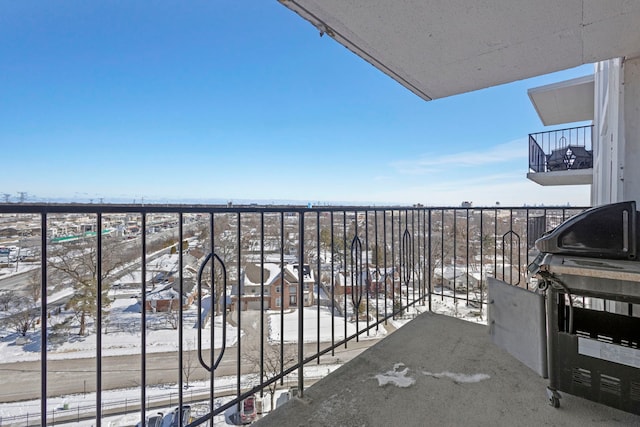 view of snow covered back of property