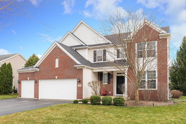 traditional-style house with aphalt driveway, brick siding, roof with shingles, a front yard, and a garage