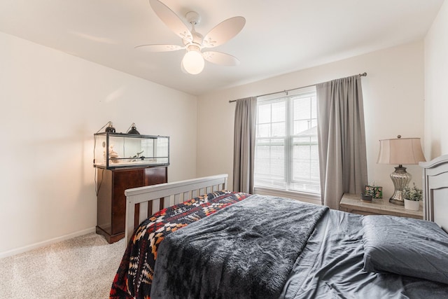 bedroom featuring a ceiling fan, carpet, and baseboards