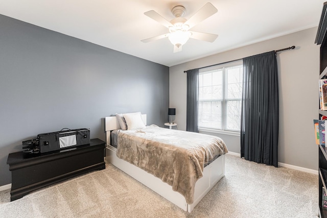 bedroom with light carpet, a ceiling fan, and baseboards