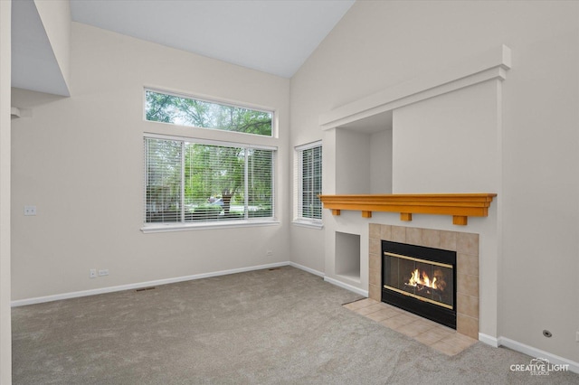 2018 Fulham Dr Unit 2018, Naperville, IL 60564 - unfurnished living room with a tile fireplace, carpet flooring, vaulted ceiling, and baseboards