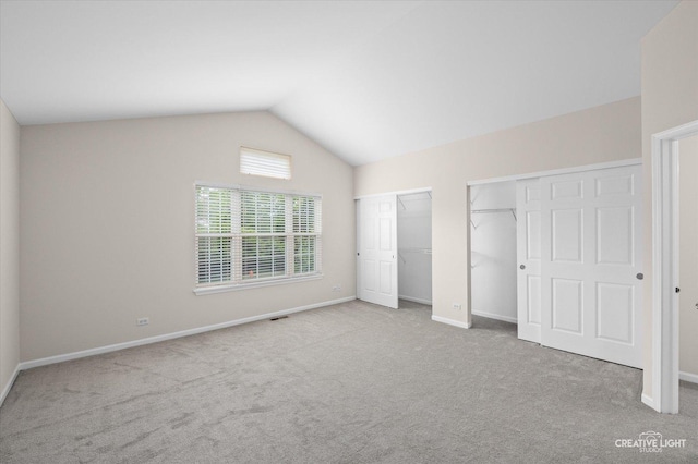 2018 Fulham Dr Unit 2018, Naperville, IL 60564 - unfurnished bedroom featuring multiple closets, carpet flooring, lofted ceiling, and baseboards