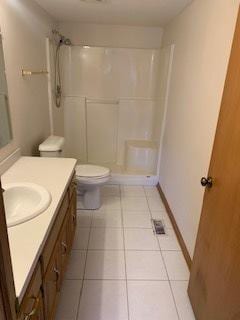 bathroom with vanity, walk in shower, and toilet