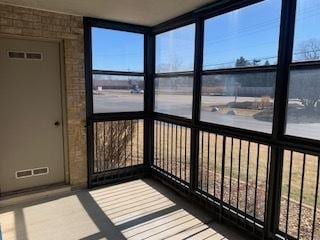 unfurnished sunroom featuring visible vents