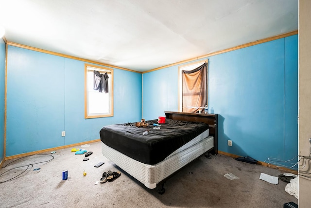 bedroom featuring carpet flooring, crown molding, and baseboards