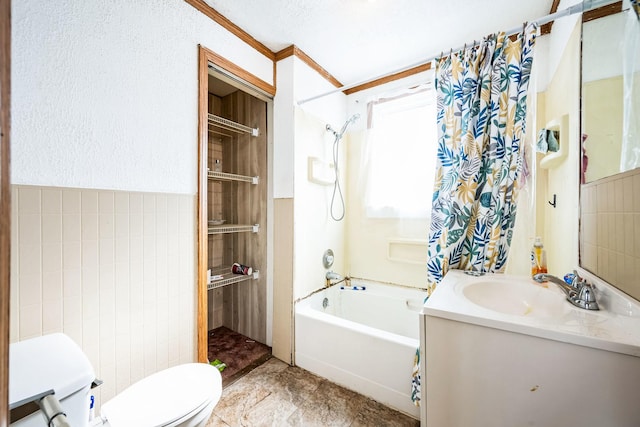 bathroom featuring toilet, vanity, tile walls, and shower / bathtub combination with curtain