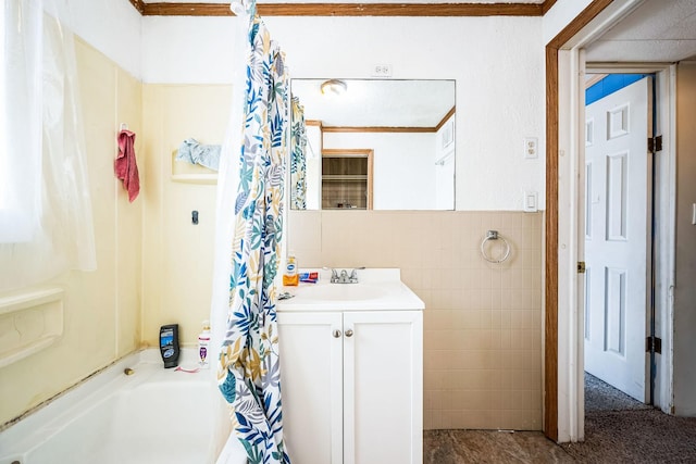 bathroom with shower / tub combo with curtain, tile walls, and vanity