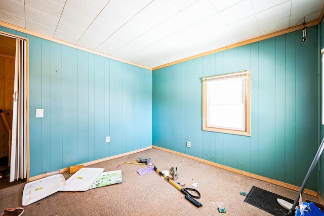 spare room featuring ornamental molding and baseboards