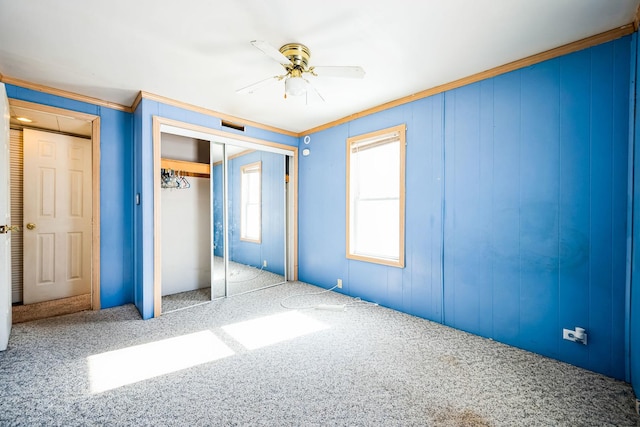 unfurnished bedroom with light carpet, a closet, and crown molding