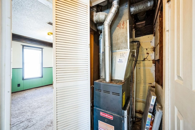 utility room featuring heating unit