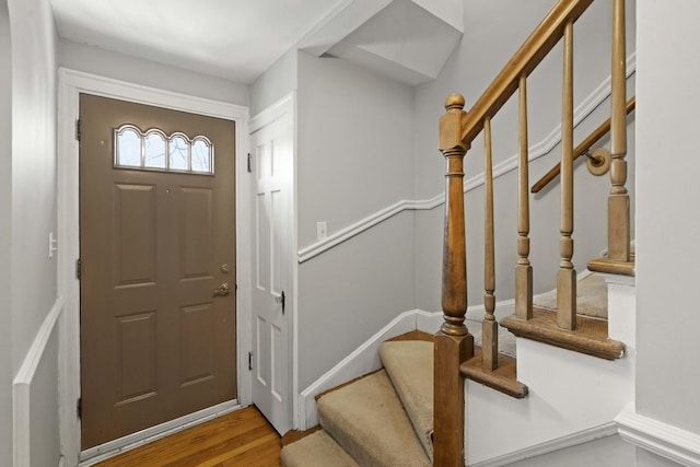 entryway featuring stairway and wood finished floors