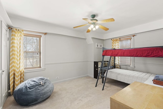 carpeted bedroom with baseboards and a ceiling fan