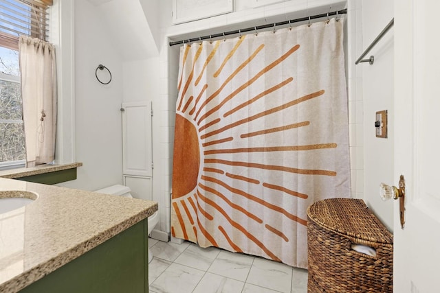 bathroom with vanity, toilet, a shower with curtain, and marble finish floor