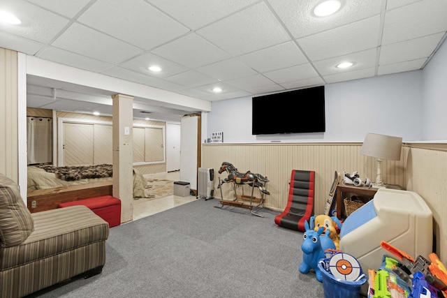 game room featuring a wainscoted wall, a drop ceiling, radiator heating unit, recessed lighting, and carpet flooring