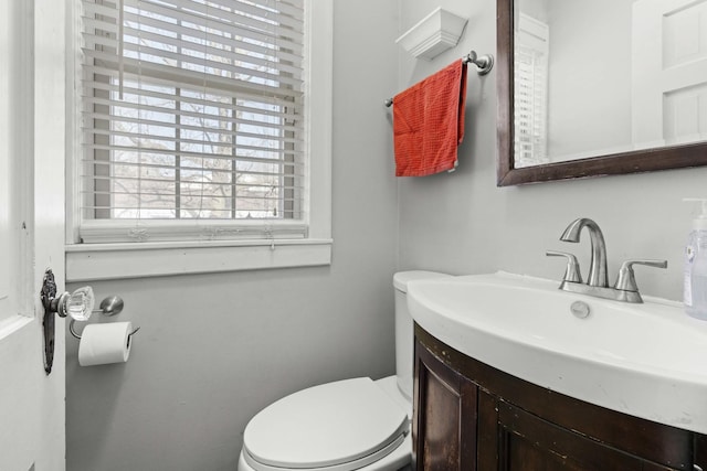 half bath featuring toilet and vanity