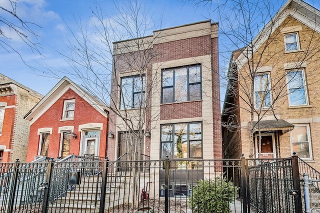 view of front of property with brick siding and a fenced front yard