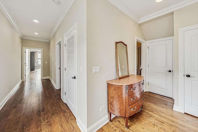 hall with recessed lighting, wood finished floors, baseboards, and ornamental molding