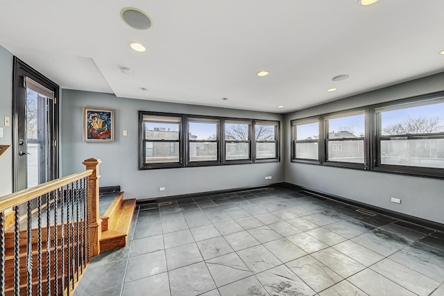 unfurnished room featuring recessed lighting and baseboards