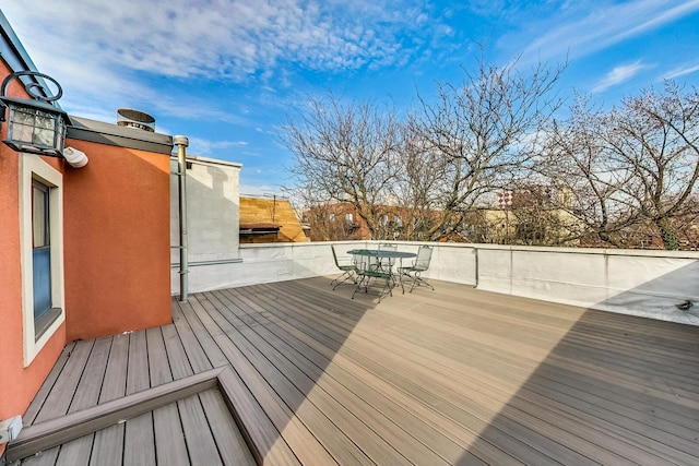 wooden terrace with outdoor dining space