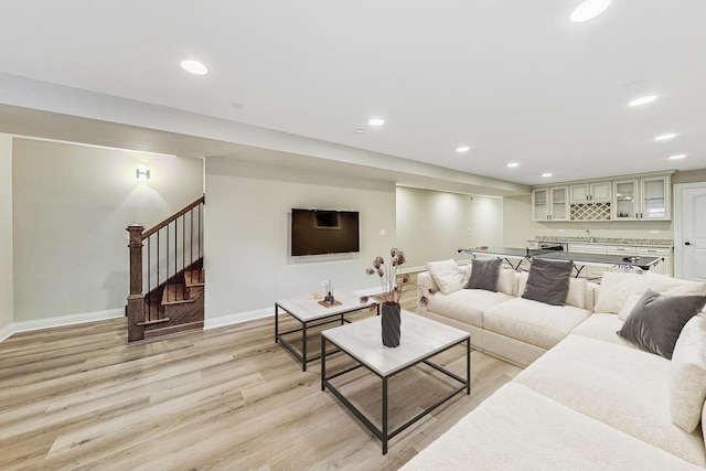 living area featuring stairway, recessed lighting, and light wood-style floors