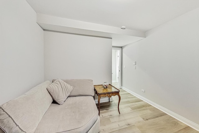 living area with light wood-style floors and baseboards