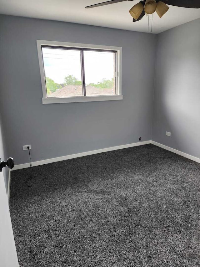 carpeted empty room featuring baseboards, a healthy amount of sunlight, and ceiling fan