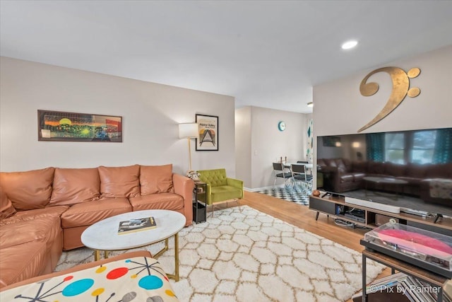 living area featuring recessed lighting, baseboards, and wood finished floors