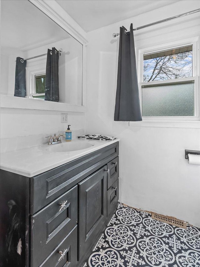 bathroom featuring tile patterned flooring and vanity