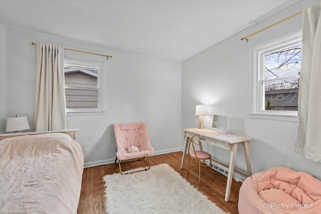 bedroom featuring baseboards and wood finished floors