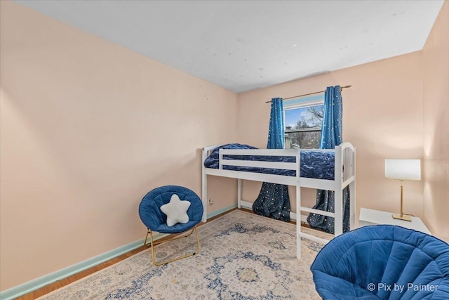 bedroom with baseboards and wood finished floors