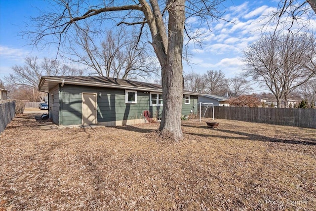 back of house with a fenced backyard