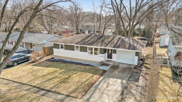 ranch-style home featuring fence, a garage, a residential view, driveway, and a front lawn