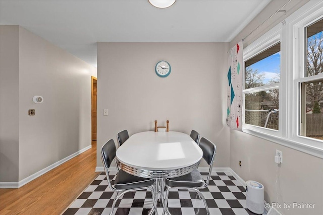 dining space featuring baseboards and tile patterned floors