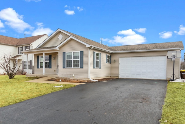 single story home with an attached garage, driveway, and a front lawn