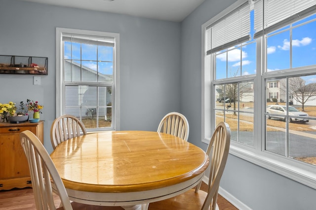 dining area featuring wood finished floors and baseboards