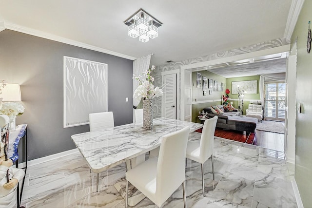 dining area with marble finish floor, baseboards, and crown molding