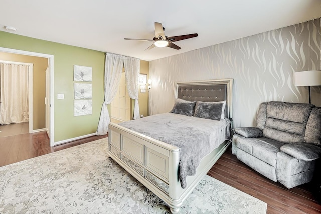 bedroom with dark wood-style floors, baseboards, and a ceiling fan