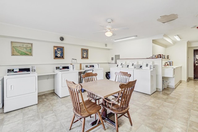 dining area featuring washing machine and dryer, baseboards, and a ceiling fan