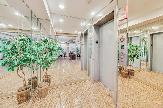 hall with recessed lighting, tile patterned floors, and elevator